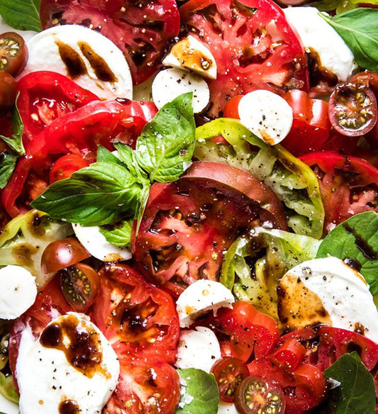 Caprese Salad - Fresh Mozzarella, Heirloom Cherry Tomato, Fresh Basil, Basil Pesto Vinaigrette, and Balsamic Syrup