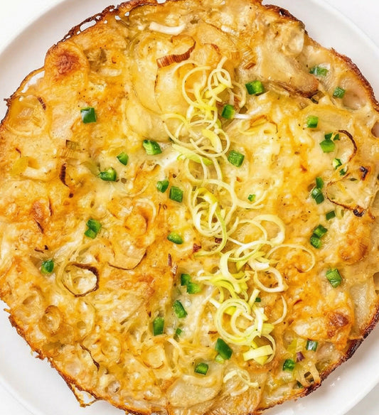 West Coast Scalloped Potato Gratin, with White Cheddar and Goat Cheese, Caramelized Leek, Bit of Jalapeño and Garlic