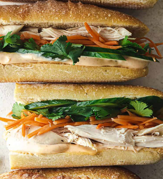 Grilled Lemongrass Ginger Chicken Breast, Pickled Vegetables, Mint, Cucumber, Cilantro, Carrot, Sriracha Aioli, French Roll